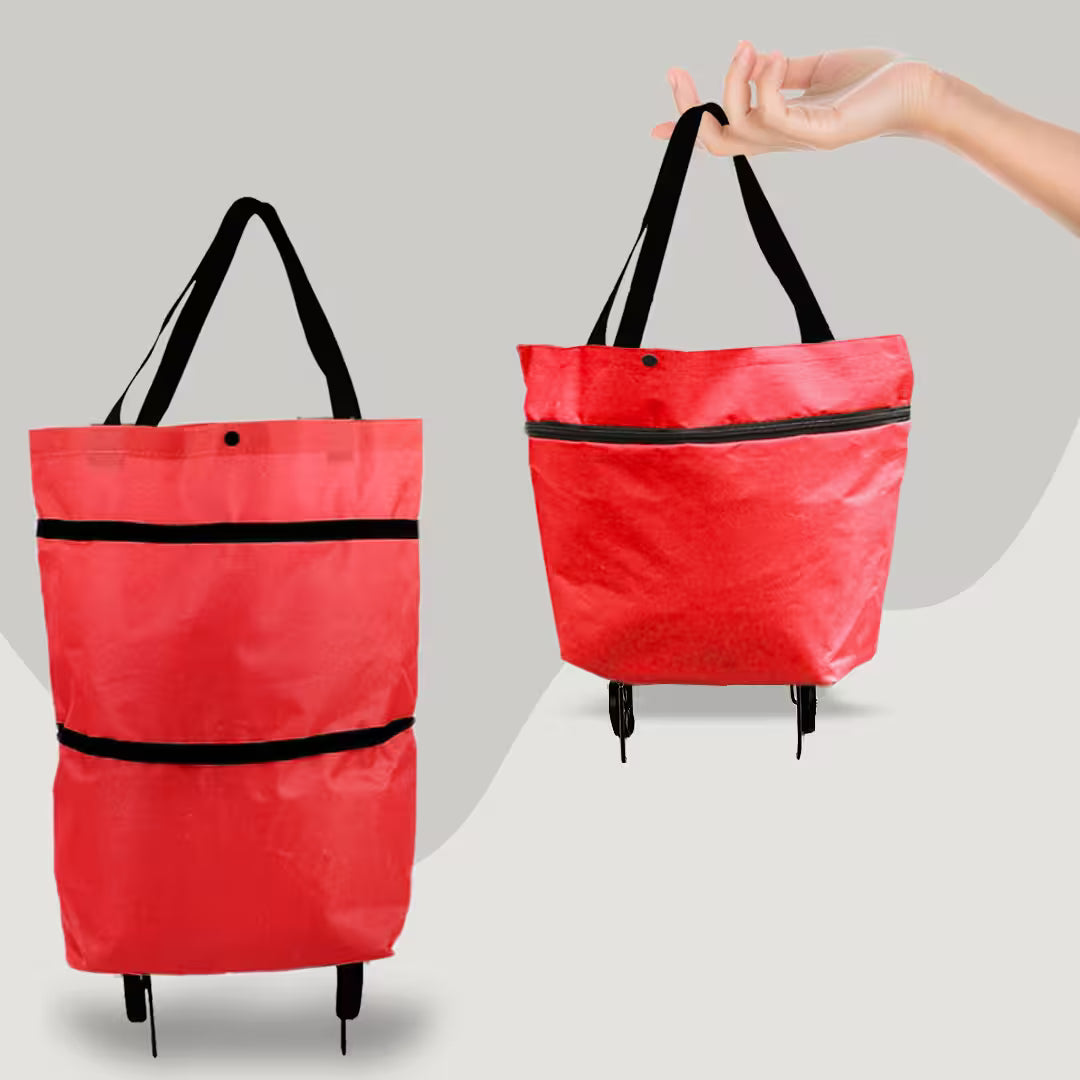 Red tote bag with black straps held by a hand on a gray background