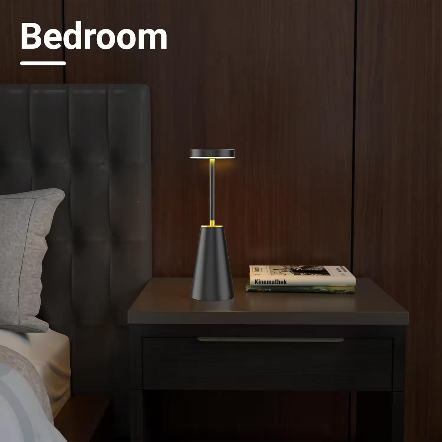 Bedroom scene with a nightstand lamp and books on a wooden nightstand.