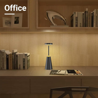 Desk with a lamp and books in an office setting