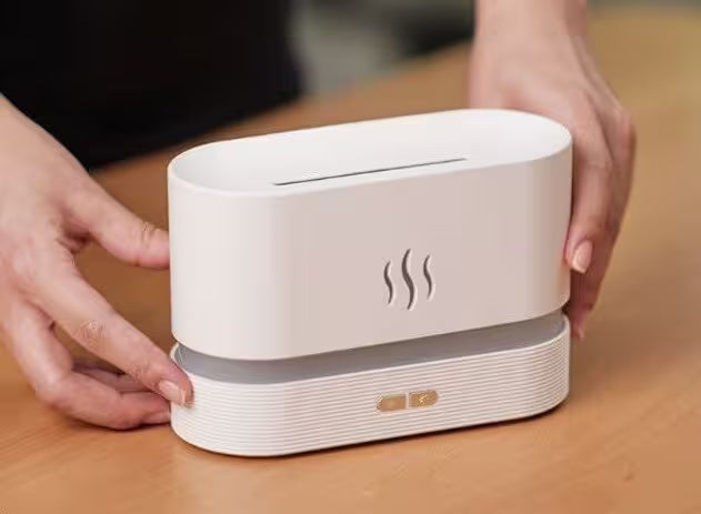 White electronic device with steam symbol on a wooden surface