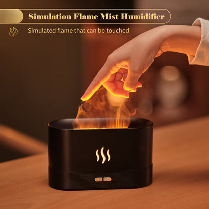 Simulation flame mist humidifier with a hand touching the 'flame', on a wooden surface.