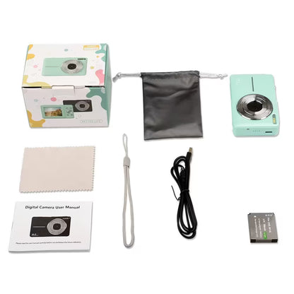 Mint green digital camera with accessories on a white background