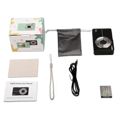 Digital camera set with packaging, camera, battery, cable, and user manual on a white background
