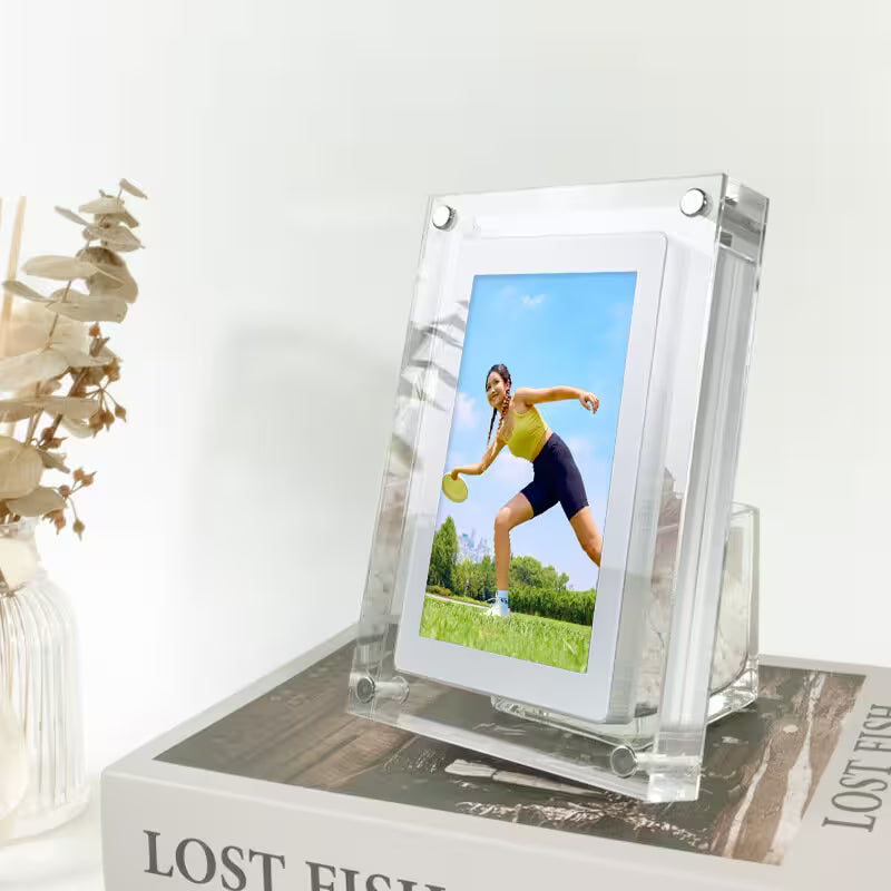Clear acrylic photo frame with a picture of a woman playing tennis on a white surface.