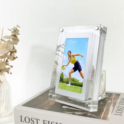 Clear acrylic photo frame with a picture of a woman playing tennis on a white surface.
