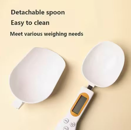 Digital kitchen scale with detachable spoon on a beige background