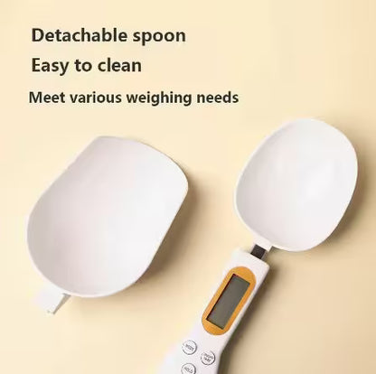 Digital kitchen scale with detachable spoon on a beige background
