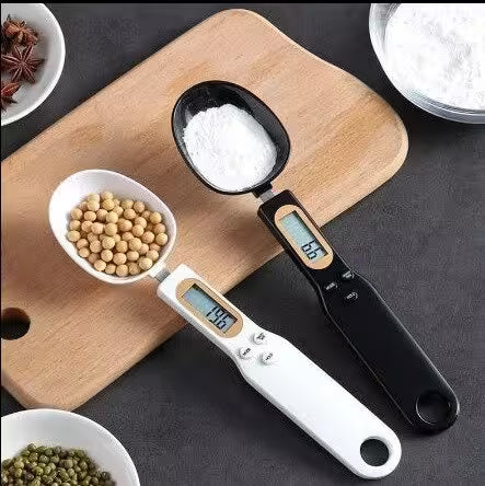 Digital measuring spoon with digital display on a wooden cutting board with ingredients