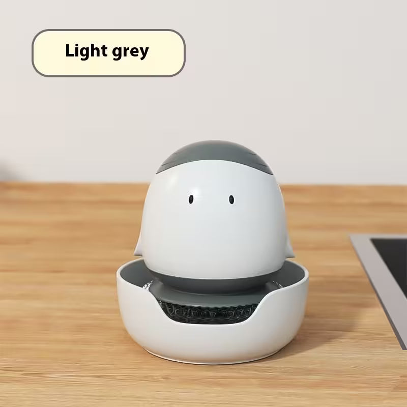 White and gray robot-like device on a wooden surface with 'Light grey' label.