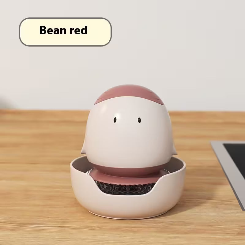 White and pink robot-like device on a wooden surface with 'Bean red' label.