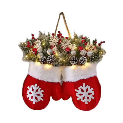 Red mittens with white snowflakes holding a Christmas wreath with lights on a white background