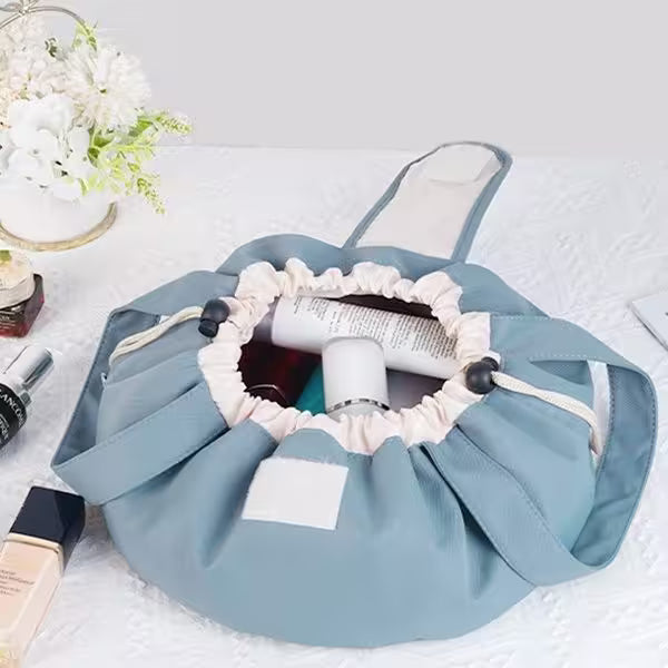 Blue cosmetic bag with white interior holding makeup items on a light background