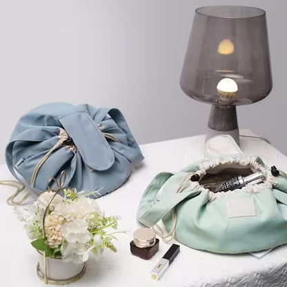 Two fabric bags on a table with a lamp and small plant in the background