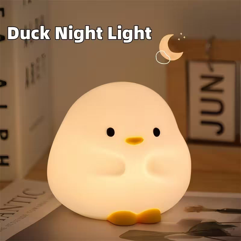 Duck-shaped night light on a table with a blurred background