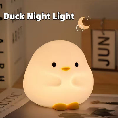 Duck-shaped night light on a table with a blurred background