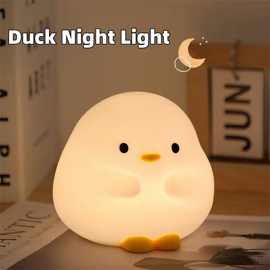 Duck-shaped night light on a table with a blurred background