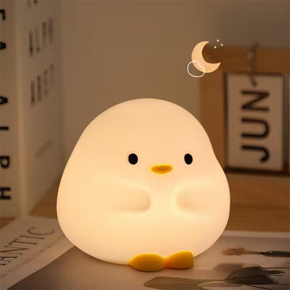 Cute chick-shaped night light on a surface with a blurred background