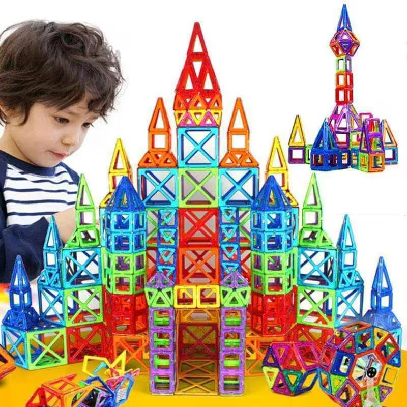 Child playing with colorful magnetic building blocks on a white background