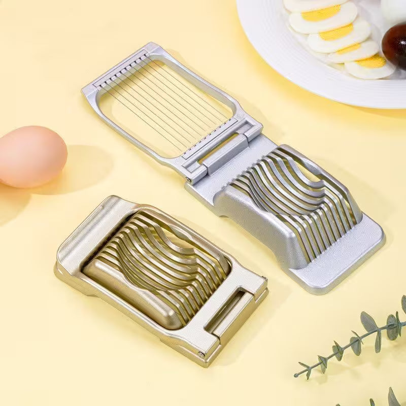 Metal vegetable slicer on a yellow background with a plate of sliced vegetables.