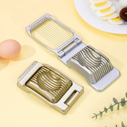 Metal vegetable slicer on a yellow background with a plate of sliced vegetables.
