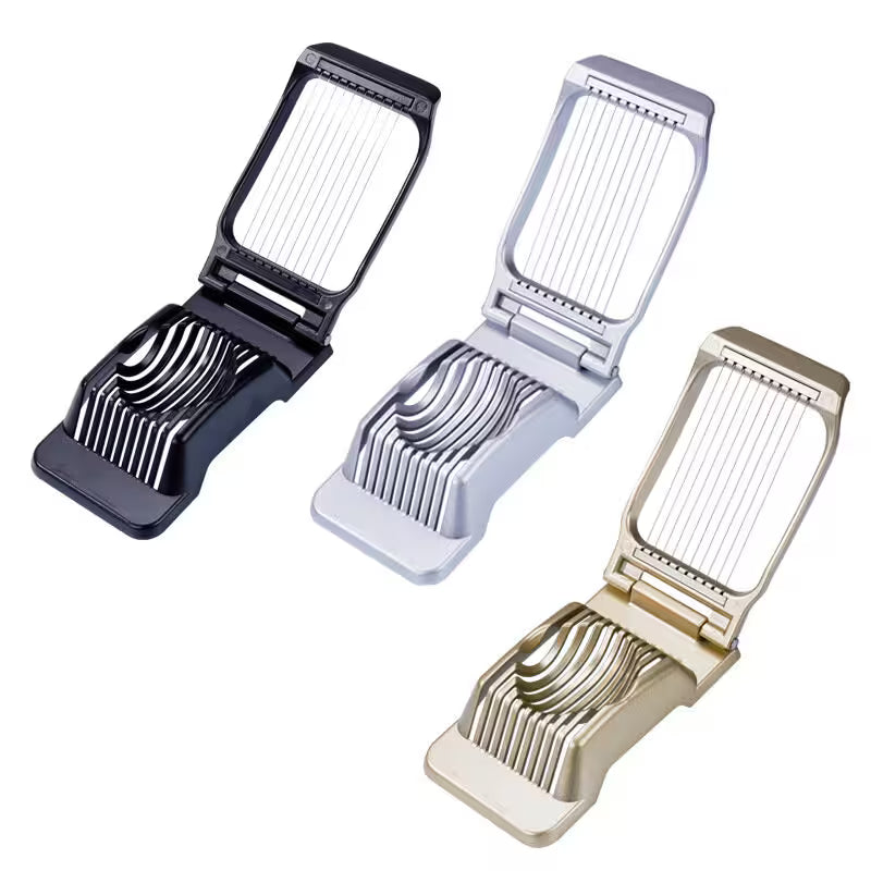 Three vegetable slicers in black, silver, and gold on a white background