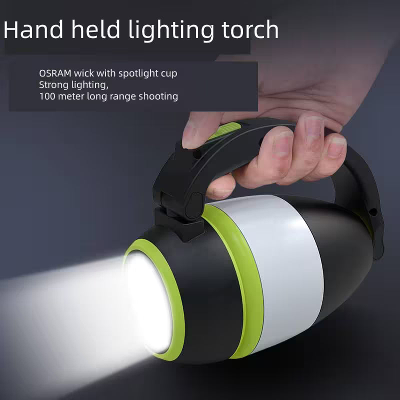Handheld lighting torch with OSRAM wick and spotlight cup, held by a hand on a dark background.