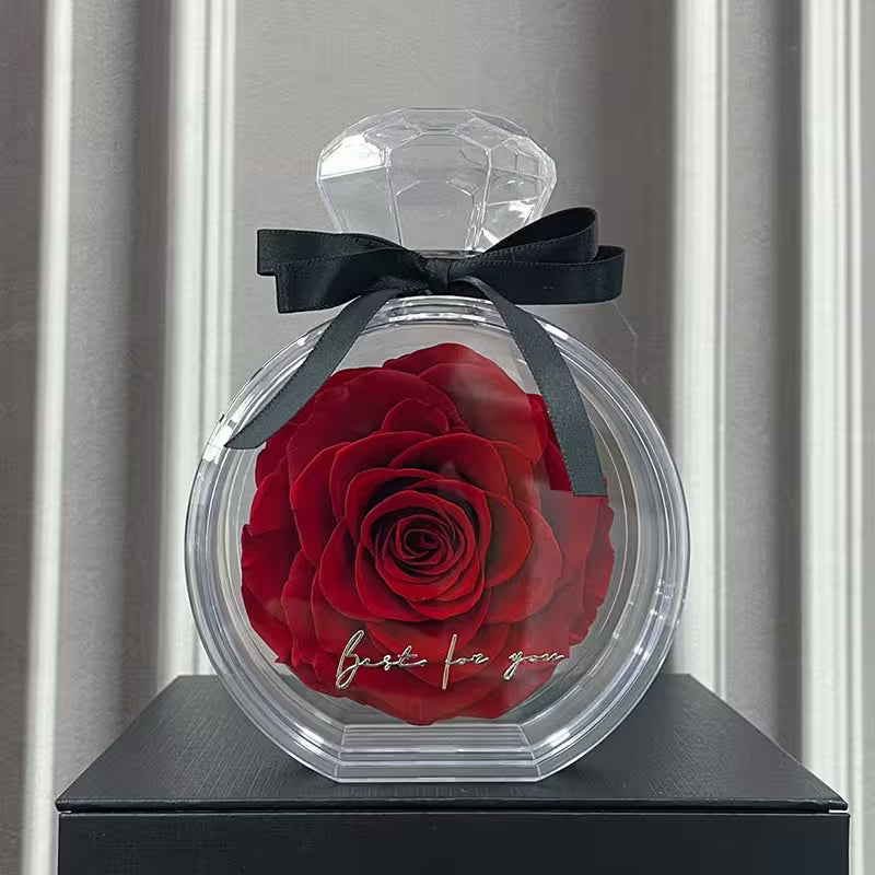 Decorative bottle with a red rose and 'best for you' text on a gray surface.