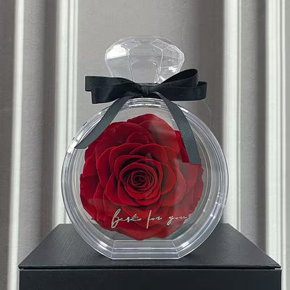 Decorative bottle with a red rose and 'best for you' text on a gray surface.