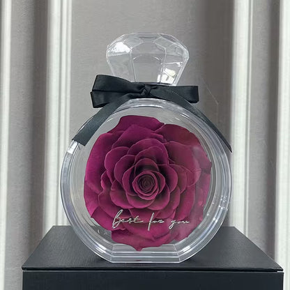 Decorative container with a preserved rose and 'best for you' text, resembling a perfume bottle.