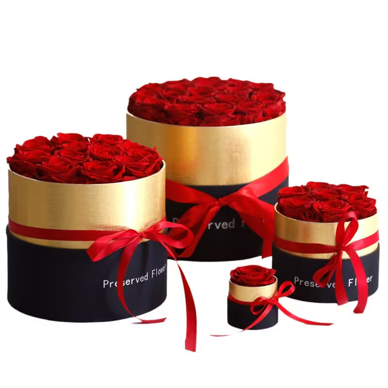 Three round boxes with red roses and red ribbons on a white background