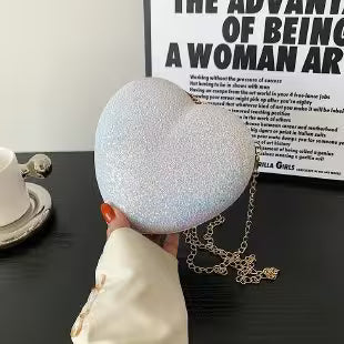 Person wearing a sparkling silver headband on a table with a poster in the background