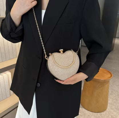 Person holding a textured handbag with a chain strap in an indoor setting
