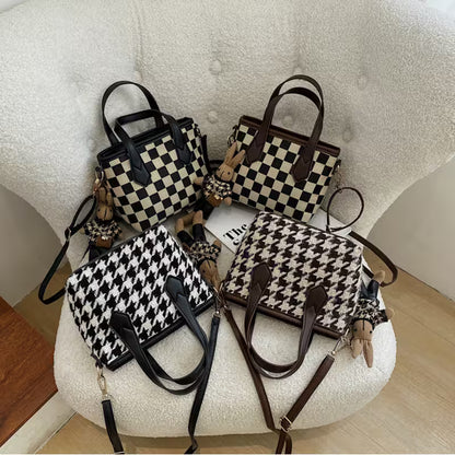 Four handbags with checkered and houndstooth patterns on a textured surface.