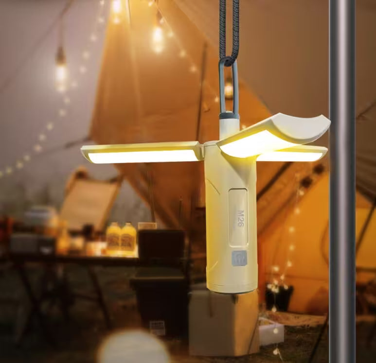 Portable camping light with a blurred background of a tent and outdoor setting