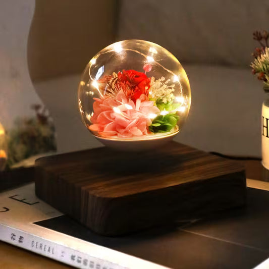 Decorative light bulb with flowers inside on a wooden base