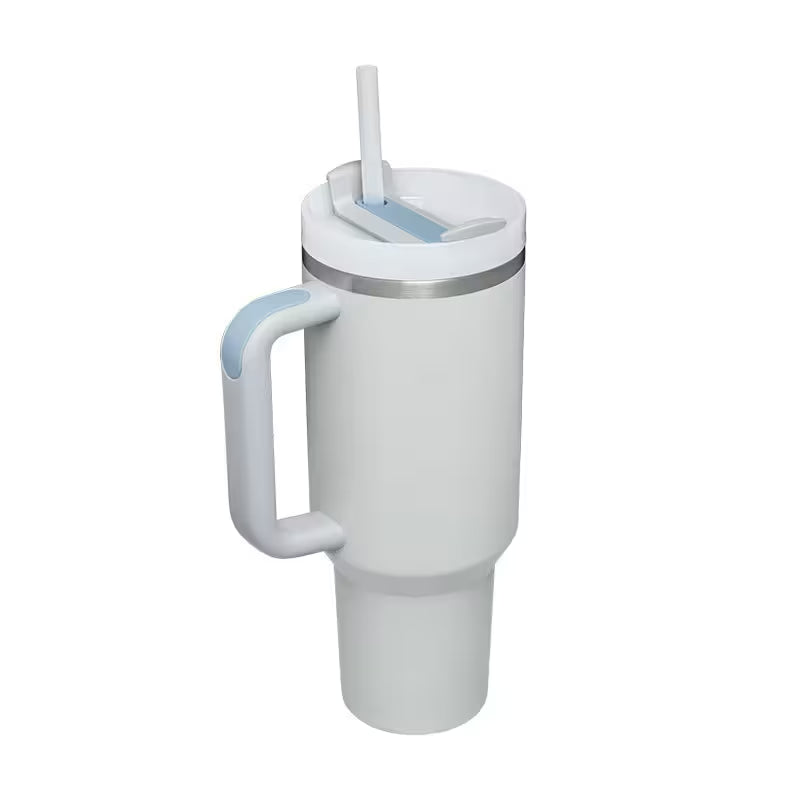 White tumbler with handle and straw on a white background