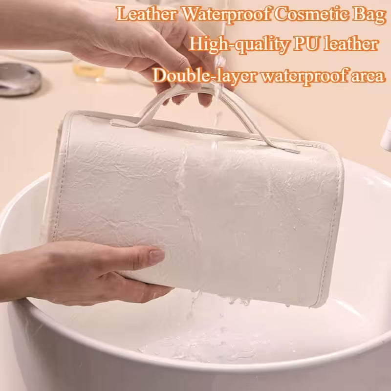 White cosmetic bag being held above a sink with water dripping off, highlighting its waterproof feature.