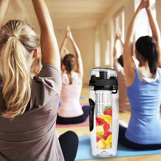 People exercising in a fitness class with a water bottle featuring fruit infusers.