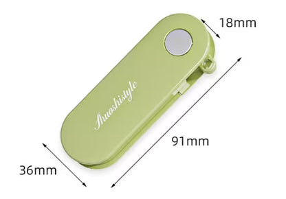 Green hair clip with dimensions labeled on a white background