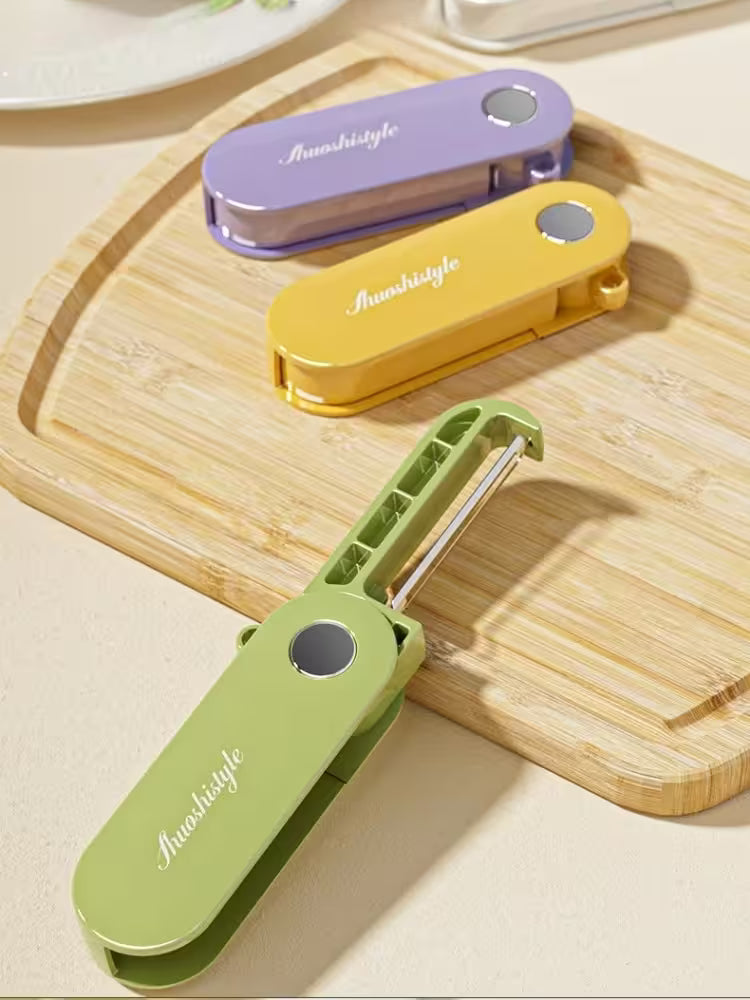 Three colorful vegetable peelers on a wooden cutting board with 'Anmashitge' branding.