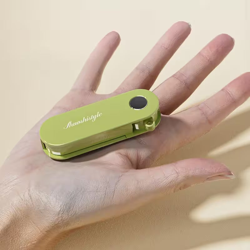 Green device with 'Jwoshistyle' branding held in a hand against a beige background