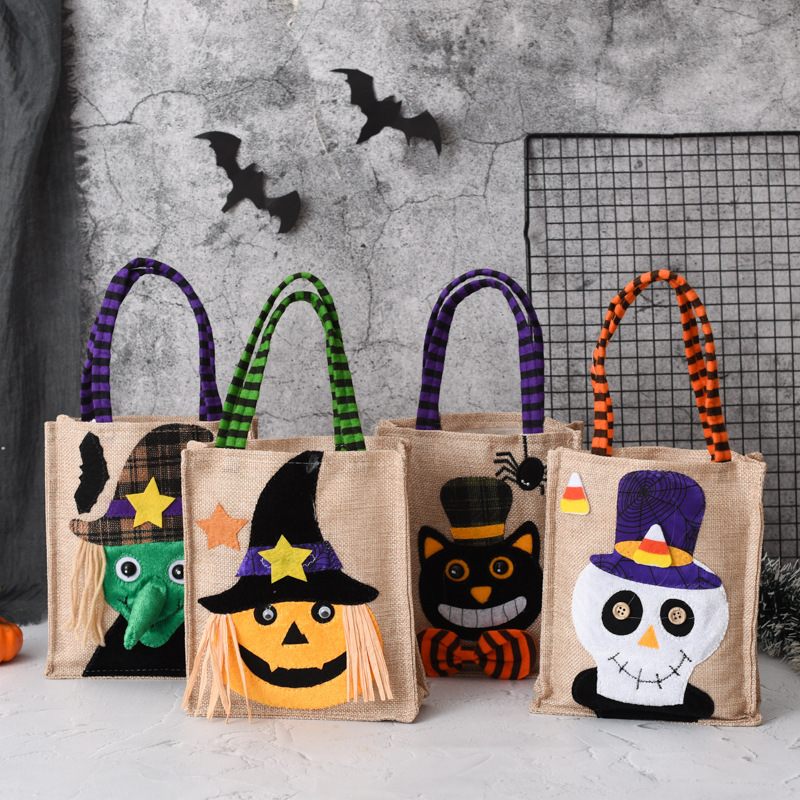 Set of Halloween-themed jute bags with decorative handles and faces on a neutral background.