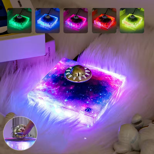 Colorful LED light-up box with starry design on a fluffy white surface.