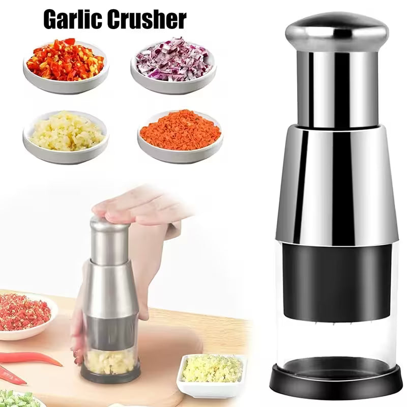 Garlic crusher with garlic and vegetables on a white background