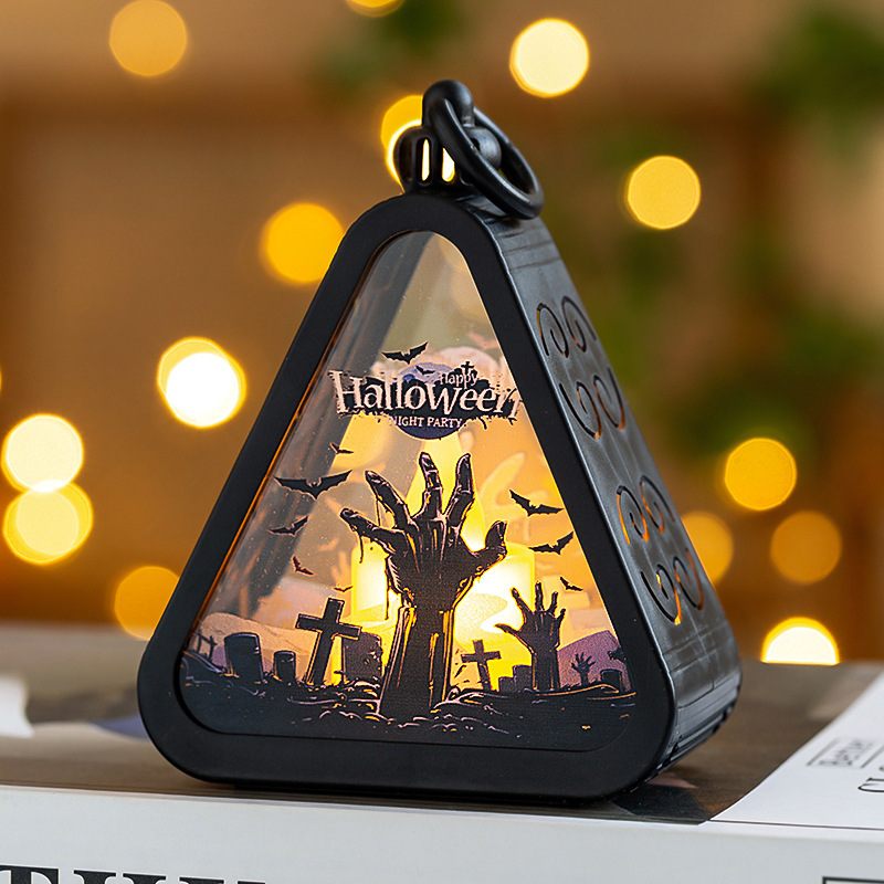 Halloween-themed decorative light with a triangular design on a blurred background with lights.