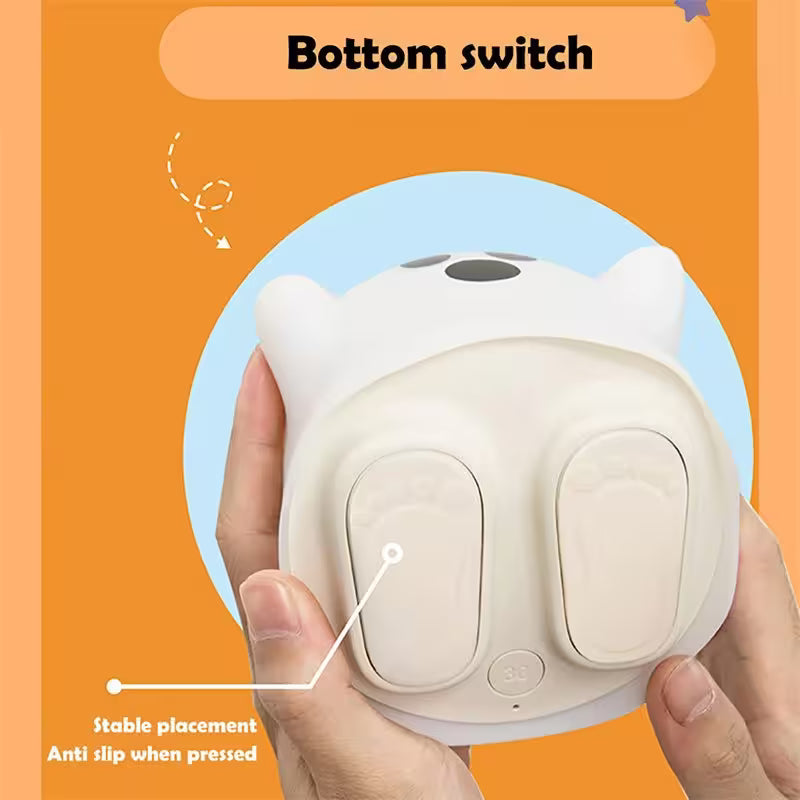 White night light with cat design held by a hand on an orange background, highlighting the bottom switch.