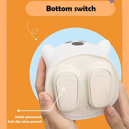 White night light with cat design held by a hand on an orange background, highlighting the bottom switch.