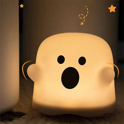 Cute ghost-shaped night light with a surprised expression on a dark background