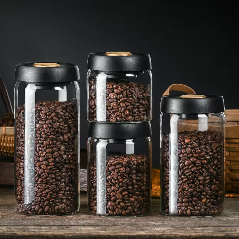 Set of glass jars with coffee beans on a wooden surface