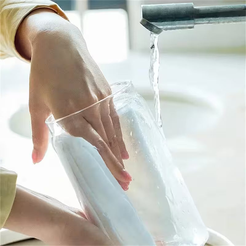 Person filling a clear plastic bag with water from a faucet.